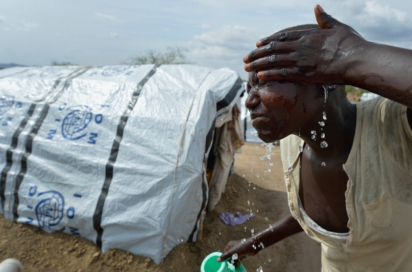 A woman washes her face on March 12, 2014 in a camp for almost 500 internally displaced people located at the St. Vincent de Paul Catholic parish on the edge of Juba. The families here fled fighting that broke out in December 2013.