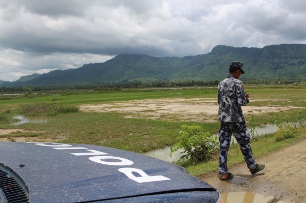 A Border Guard Police officer conducts a patrol on the outskirts of Kyar Gaung Taung village, Maungdaw Township on July 15
