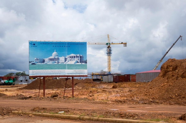 After spending several million dollars on government buildings in Malabo, the capital,and Bata, the nation’s economic center, Equatorial Guinea is pouring billions of dollars into building a new administrative capital, Oyala, in the middle of the jungle. The IMF estimates that spending on Oyala would consume half the 2016 national budget. Above is the construction site with a billboard advertising the planned senate building in Oyala.
