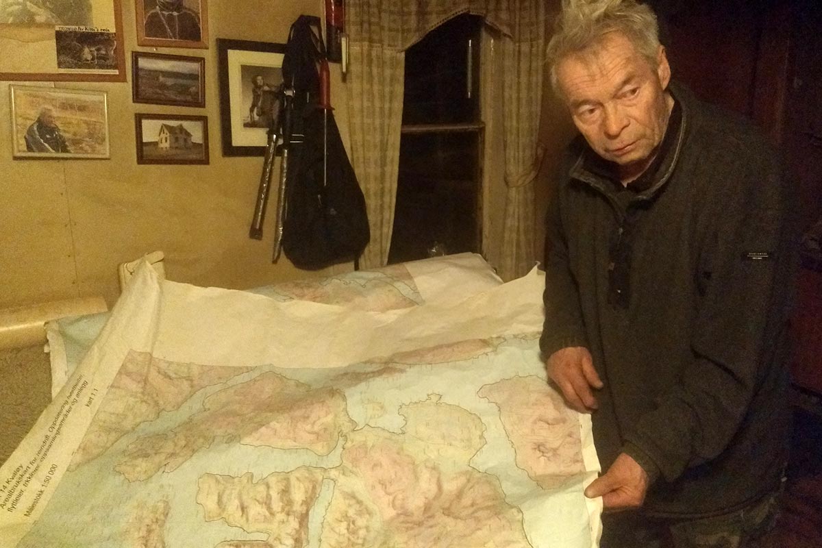 Inside his little house, Per Kitti shows a map