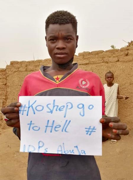 A young occupant of the al-Salam camp holding a sign