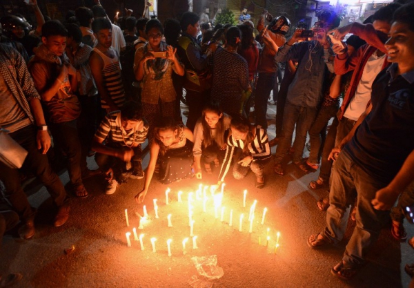 Nepalese people light candles as they celebrate the country's new national constitution near the constituent assembly building in Kathmandu on September 20, 2015. Nepal on September 20 adopted a new constitution aimed at bolstering its transformation to a peaceful democracy after decades of instability and a long civil war, even as protests raged over its terms.