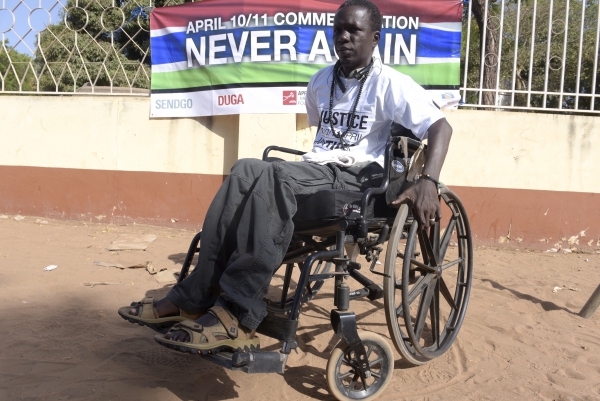 Yusuf Mbye, 35, demonstrates with other victims of the Jammeh regime. He was injured in a protest in 2000 and has been paralysed ever since.