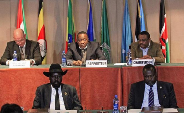South Sudan's President Salva Kiir (bottom L) and South Sudan's rebel commander Riek Machar (bottom R), together with African Union Commissioner for Peace and Security Smail Chergui (top L), Kenya's President Uhuru Kenyatta (top C) and Ethiopia's Prime Minister Hailemariam Desalegn, attend the signing a ceasefire agreement during the Inter Governmental Authority on Development Summit on the case of South Sudan in Ethiopia's capital Addis Ababa, Feburary 1, 2015.