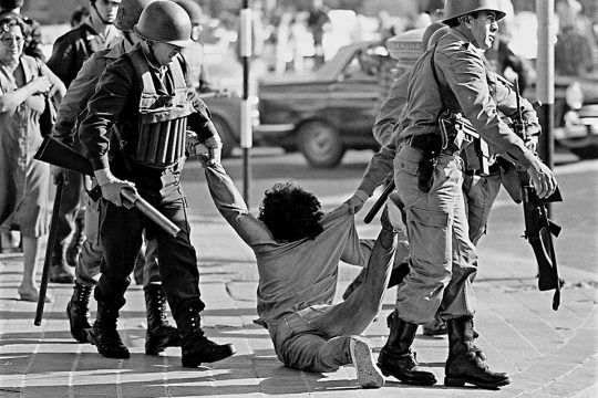 In Argentina, a man is dragged on the ground by the military