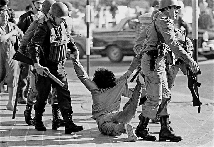 In Argentina, a man is dragged on the ground by the military