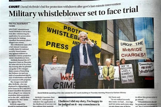 War Crimes in Afghanistan - Article in The Canberra Times (Australia) headlined: "Military whistleblower set to face trial". Pictured in the article: David McBride holding a microphone during a demonstration.