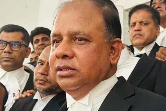 Aminul Islam becomes the new chief prosecutor of the International Crimes Tribunal (ICT) in Bangladesh. Photo: Lawyers in traditional dress are gathered together. Aminul Islam is in the foreground and Tajul Islam is behind him.