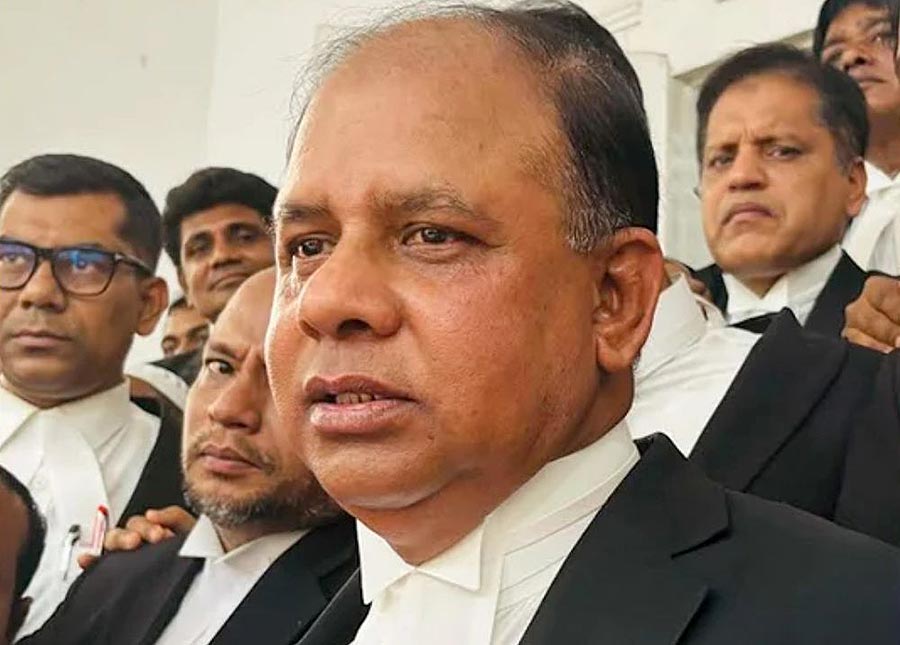 On the left (wearing glasses) Tajul Islam, former prosecutor of the International Crimes Tribunal for Bangladesh, and in the foreground on the right his successor Aminul Islam, during their handover of power in Dhaka on Monday 23 February 2026. Photo: © DR Aminul Islam becomes the new chief prosecutor of the International Crimes Tribunal (ICT) in Bangladesh. Photo: Lawyers in traditional dress are gathered together. Aminul Islam is in the foreground and Tajul Islam is behind him.