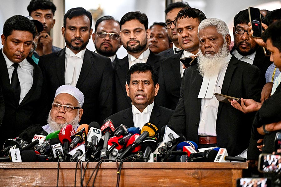 Prosecutor Mohammad Tajul Islam (ICT) The International Crimes Tribunal Bangladesh (ICT) is preparing to try Sheikh Hasina. Photo: ICT Chief Prosecutor Mohammad Tajul Islam stands in the centre of a group of men in black suits, facing microphones, during a press conference.