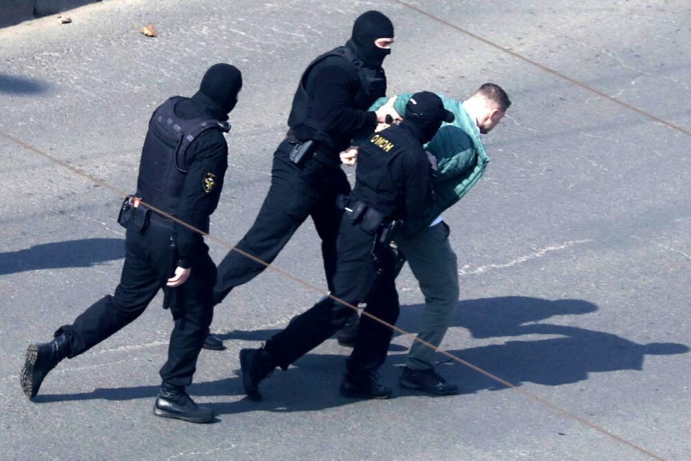 According to experts and human rights activists, Belarus continues to produce political prisoners who are used as bargaining chips in its negotiations with the West. Photo: © AFP Belarus uses its political prisoners as bargaining chips in political, diplomatic and economic dealings, most often with the United States. Photo: Hooded police officers have handcuffed a civilian in the street and are forcibly taking him into custody.