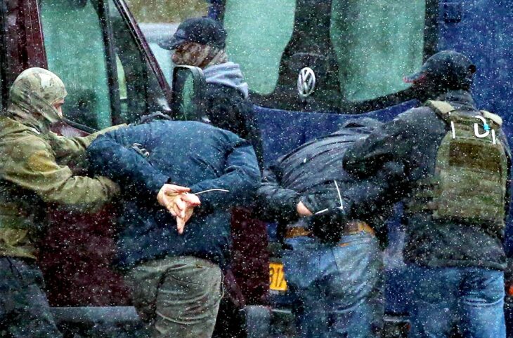 La Cour pénale internationale (CPI) ouvre une enquête approfondie en Biélorussie sur les crimes contre l'humanité présumés à l'encontre des opposants politiques (expulsions). Photo : deux manifestants sont attachés, mains derrière le dos et dos courbés, et emmenés par les forces policières biélorusses.