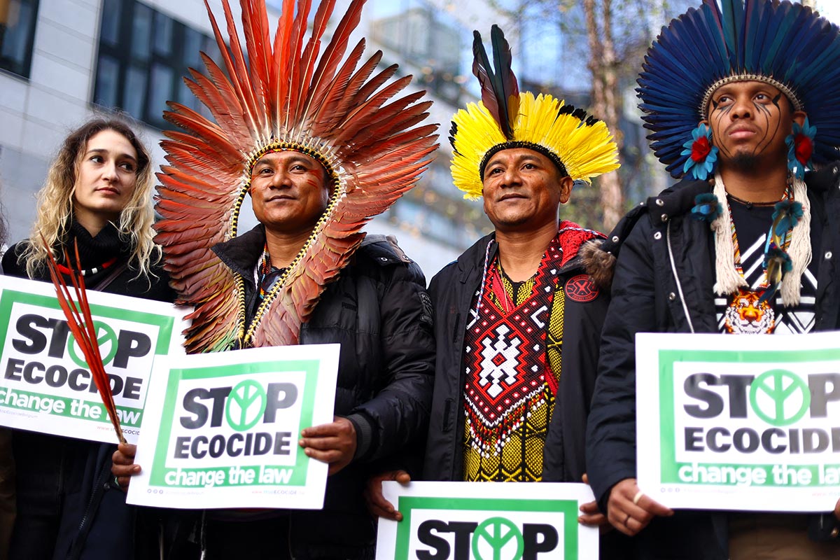 Environmental protest in Belgium for the recognition of ecocide as an international crime. Photo : Brazilian indigenous and other militants hold signs readind 