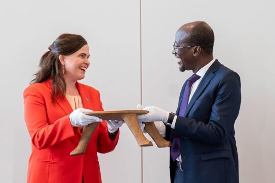 Restitution of a cultural artifact from Finland to Benin. Photo: Mari-Leena Talvitie, Finnish Minister of Science and Culture, hands over a royal stool formerly looted by France to Benin's Minister of Tourism and Culture, Jean-Michel Abimbola.