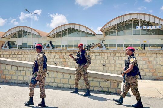 Three soldiers from the Ethiopian National Defence Forces are on patrol outside Mekelle Airport in Ethiopia.