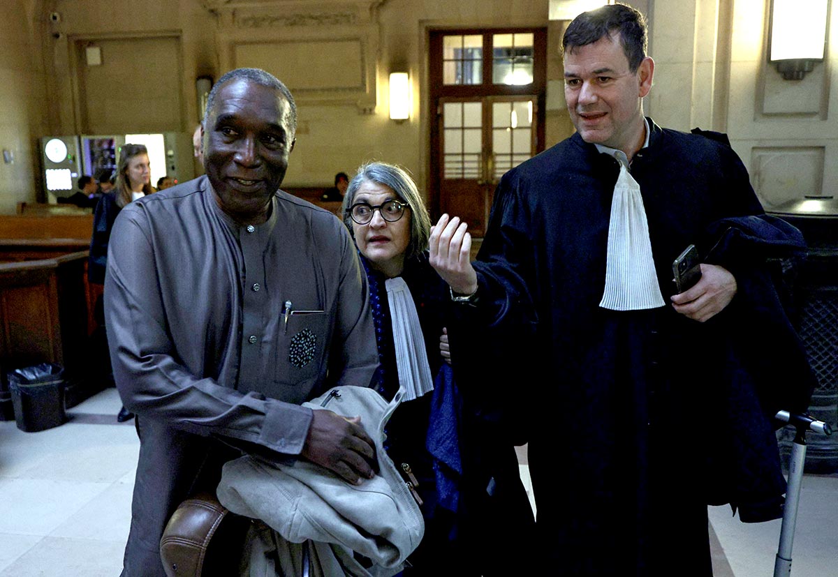 Lawyers for Rwandan doctor Eugene Rwamucyo (L) accused of participation in the 1994 Tutsi genocide, Philippe Meilhac (R) and Lawyer Mathe (C) arrive at the Paris Assize Court