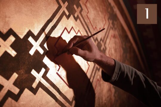 Reparations for the victims of the Church of France. Photo: A painter uses a tool to renovate a mural depicting several Catholic crosses.