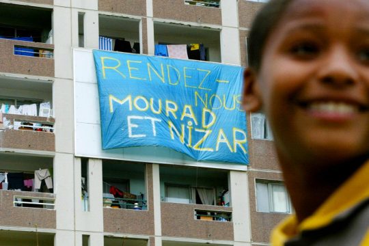 Banner on the balcony of a building in Lyon, France: 