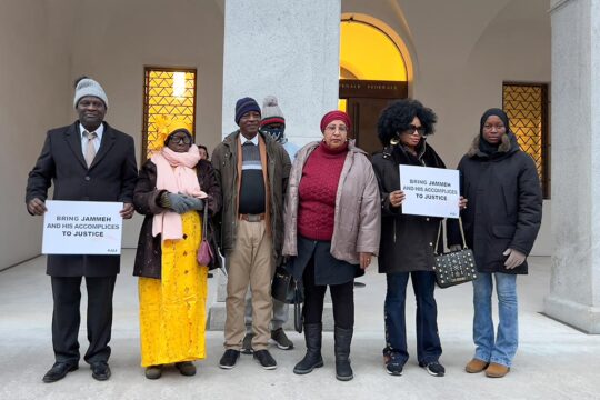 At the Ousman Sonko trial in Switzerland, Gambian plaintiffs pose at the entrance to the court in Bellinzona.