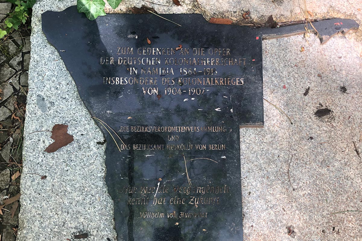 Poster next to the "Herero Stone" (Germany). It reads "In memory of the victims of German colonial rule in Namibia from 1884 to 1915, and in particular of the colonial war from 1904 to 1907".