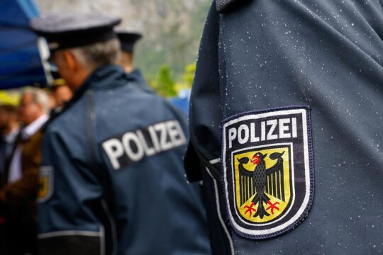The International Criminal Court (ICC) has arrested a Libyan suspect who was the subject of a secret arrest warrant. Photo: Close-up of a ‘Polizei’ badge on the arm of a German policeman in uniform.