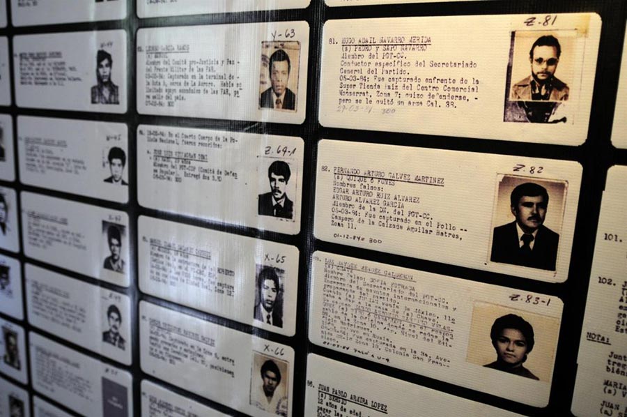 Cards of the victims listed in the "Diario Militar" are displayed on a wall (Guatemala)