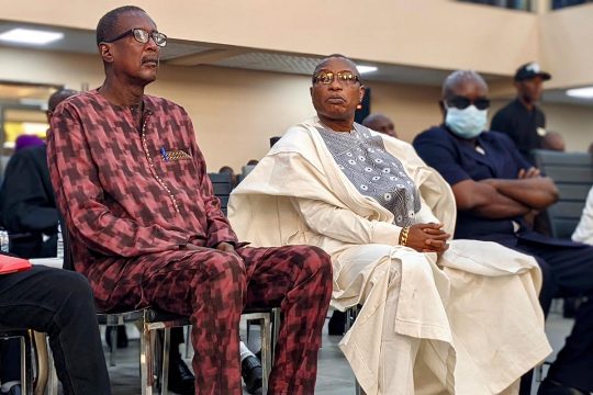 Moussa Dadis Camara (right) sits next to a co-accused during his trial in Conakry, Guinea.