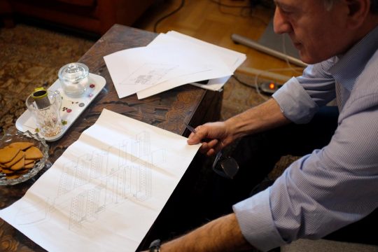 Iraj Mesdaghi displays documents on a table
