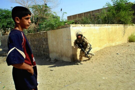 Iraqi boy and a Bristish soldier in Iraq