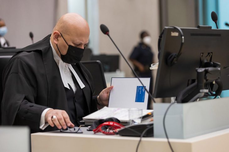Karim Khan (prosecutor) reads a file at the International Criminal Court (ICC)