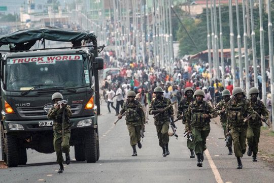 Crimes agains humanity in Kenya - Police violence during a protest in Kisumu (Kenya). Military policeman seems to shoot in front of him.