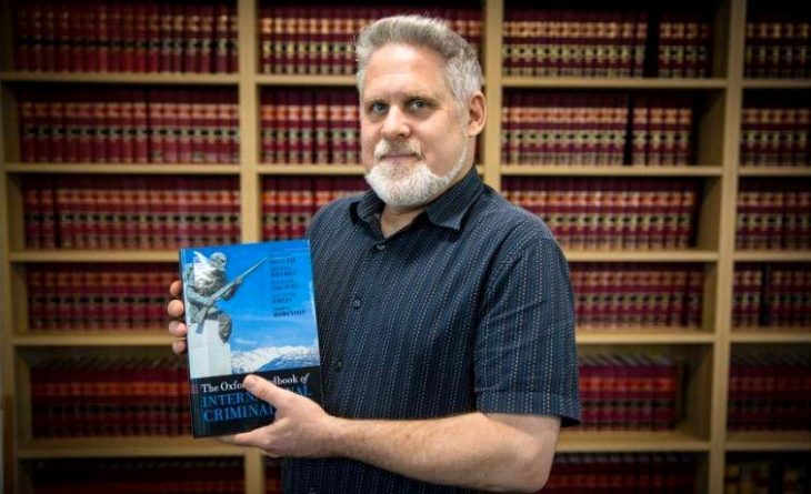 Kevin Jon Heller holds a book in his hands (he is the co-author): 