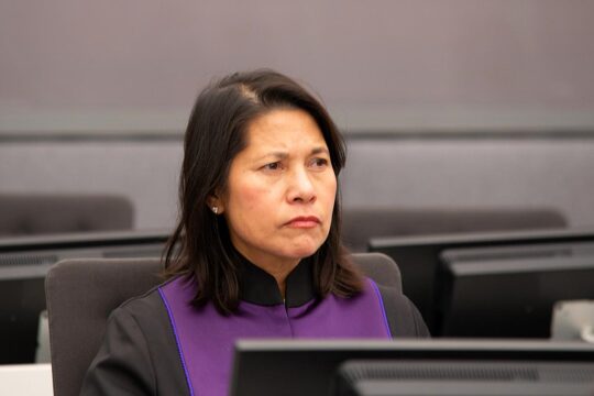 The prosecutor for the Kosovo Specialist Chambers, Kimberly West, delivered a relentless indictment of the four main defendants, including Hashim Thaçi, citing war crimes and crimes against humanity. Photo: West seated at a desk, wearing her magistrate's robe.