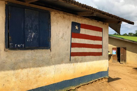 Liberian flag on the wall of a house in a village in Liberia