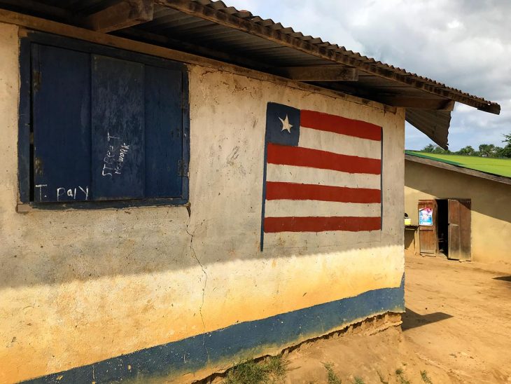 Liberian flag on the wall of a house in a village in Liberia