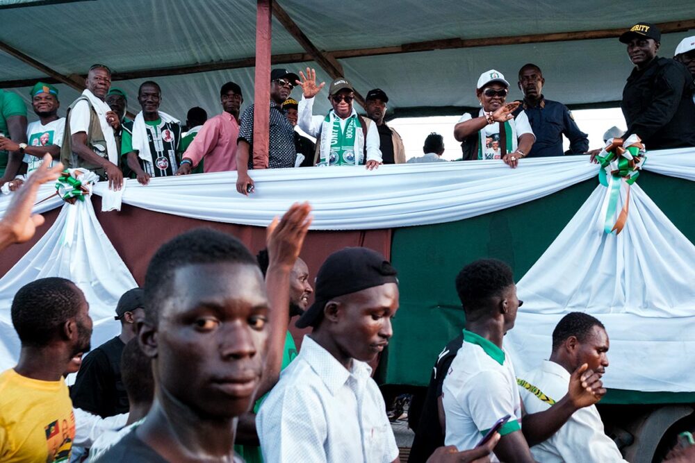 Can Joseph Boakai, Liberia's new president, be seen as a hope for justice for past war crimes? Photo: Boakai stands on a platform in front of a crowd of supporters during his election campaign.