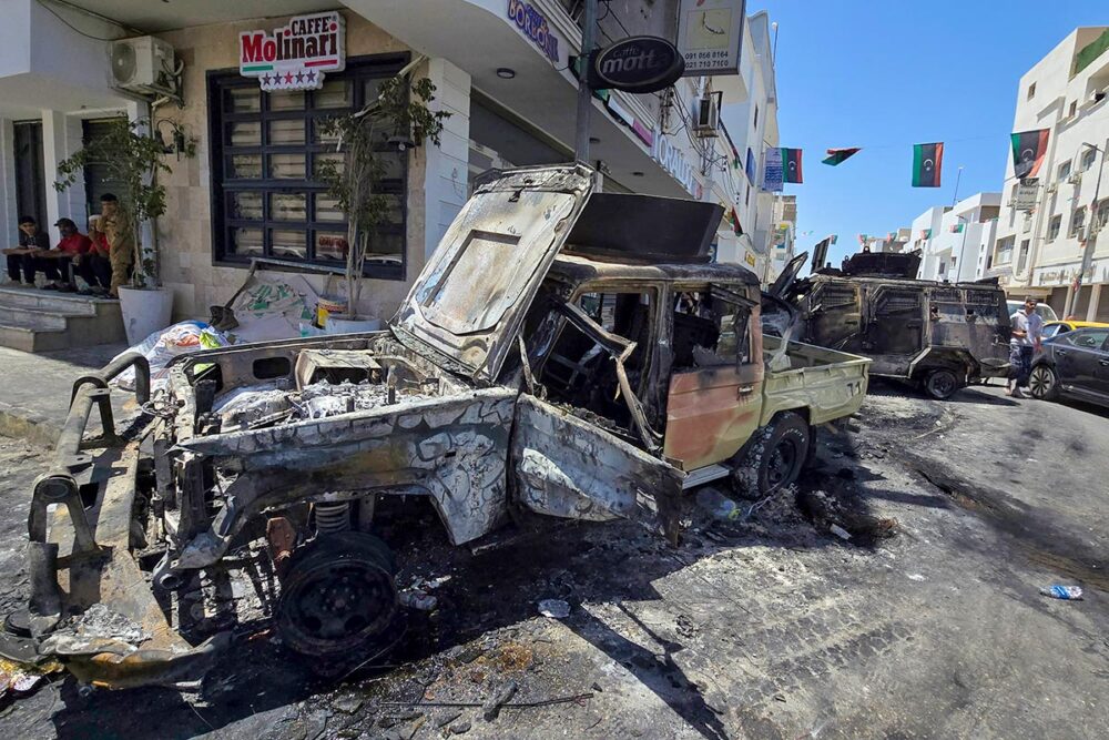 The International Criminal Court (ICC) and justice in Libya. Photo: A vehicle burnt during clashes between armed militias and government forces.