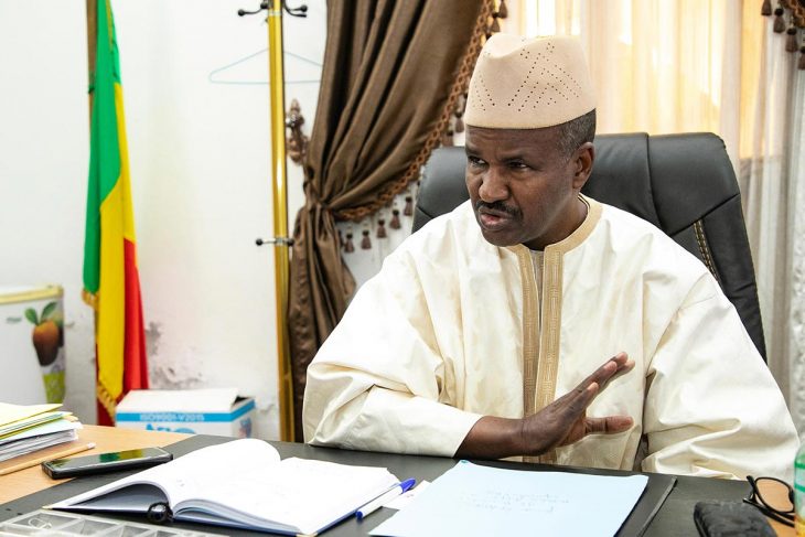 Ousmana Oumarou Sidibé, seated at his desk at the Truth Commission of Mali, answers questions from Justice Info