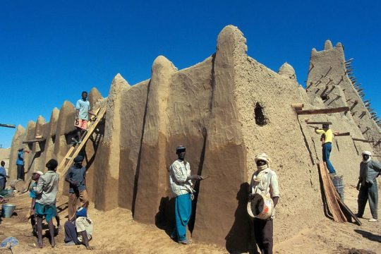 Reparations on a mausoleum in Timbuktu, Mali, by Malian workers.