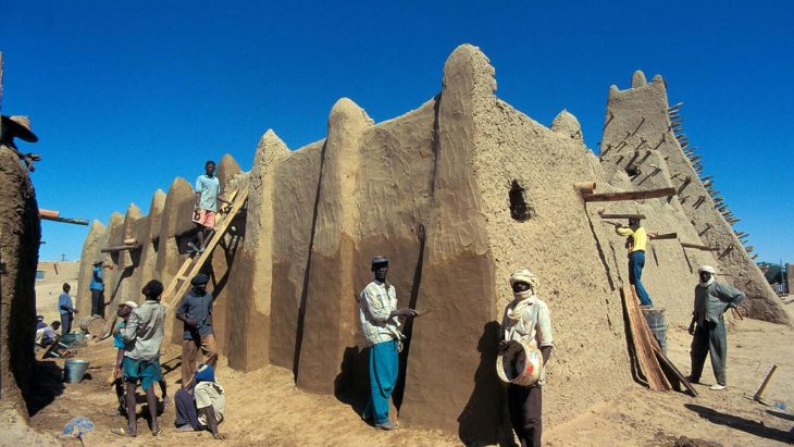 Reparations on a mausoleum in Timbuktu, Mali, by Malian workers.