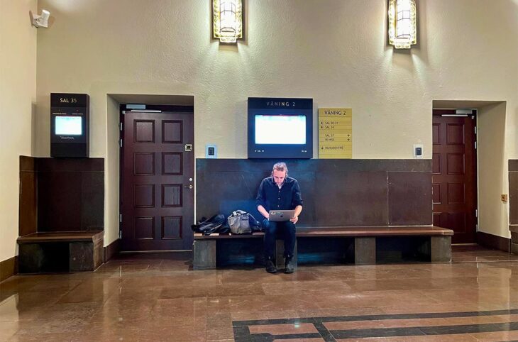Martin Schibbye is a journalist, one of the few covering the Lundin trial in Sweden. Photo: Schibbye stands alone at the entrance to courtroom 34 in Stockholm.