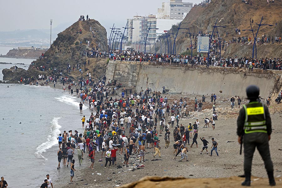 Migrants, mainly from Morocco, entering the Spanish enclave of Ceuta in large numbers in July 2026.