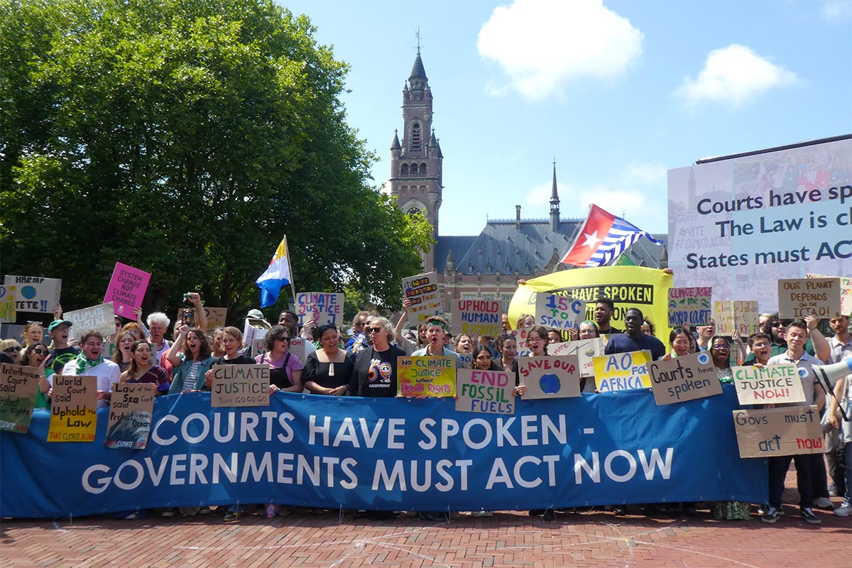 A group of activists in front of the Peace Palace (The Hague, Netherlands) after the International Court of Justice (ICJ) issued its advisory opinion on climate change. They are holding a banner that reads ‘Courts have spoken. Governments must act now.’