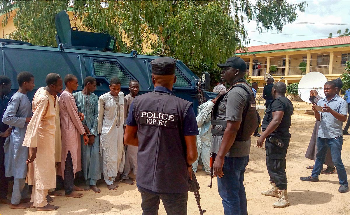 In Nigeria, Police officers display suspected Boko Haram militants