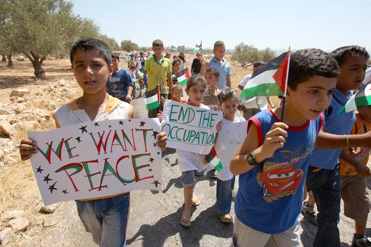 Demonstration of Palestinian children holding up signs that read 