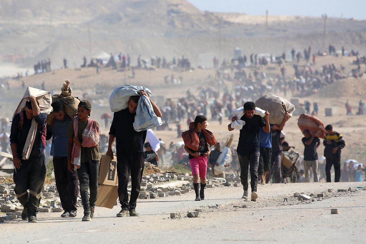 Palestinians walk away from an Israeli-controlled humanitarian aid centre (GHF) in the Gaza Strip.