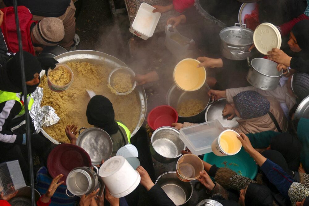 Crime of starvation in Gaza: will the ICC act? - Photo: Palestinians crowd around a food distribution point in Rafah.