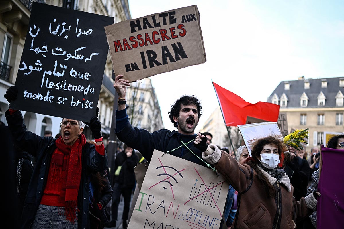 A protester holds a placard reading 