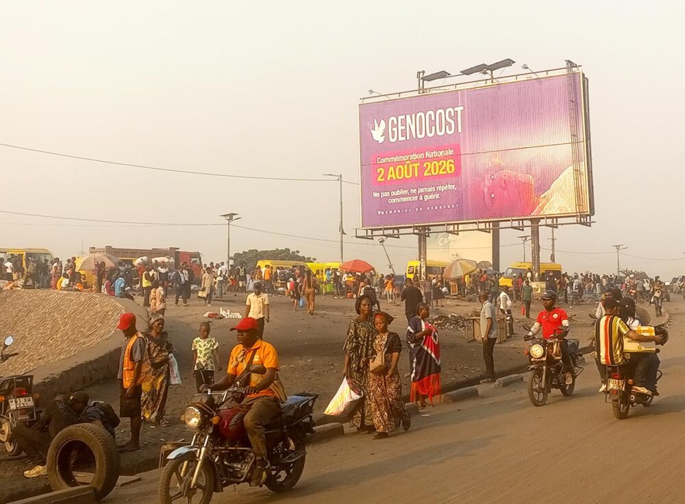 On a street in Kinshasa, in the Democratic Republic of the Congo (DRC), a large advertising hoarding displays a message about ‘Genocost’, announcing a ‘national commemoration on 2 August 2026’.