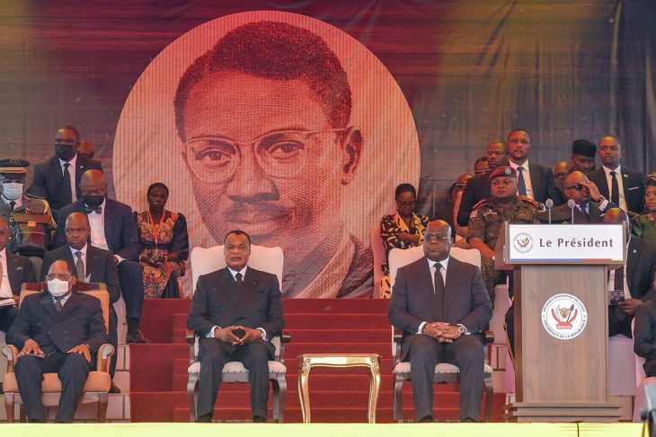 Felix Tshisekedi and Denis Sassou Nguesso (foreground) attend the funeral ceremony of Patrice Lumumba (large portrait in background).